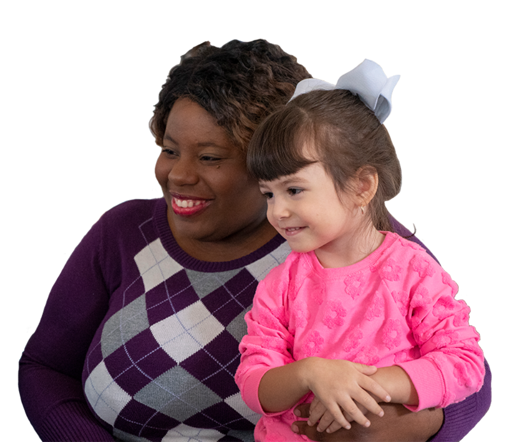 child care provider holding smiling child